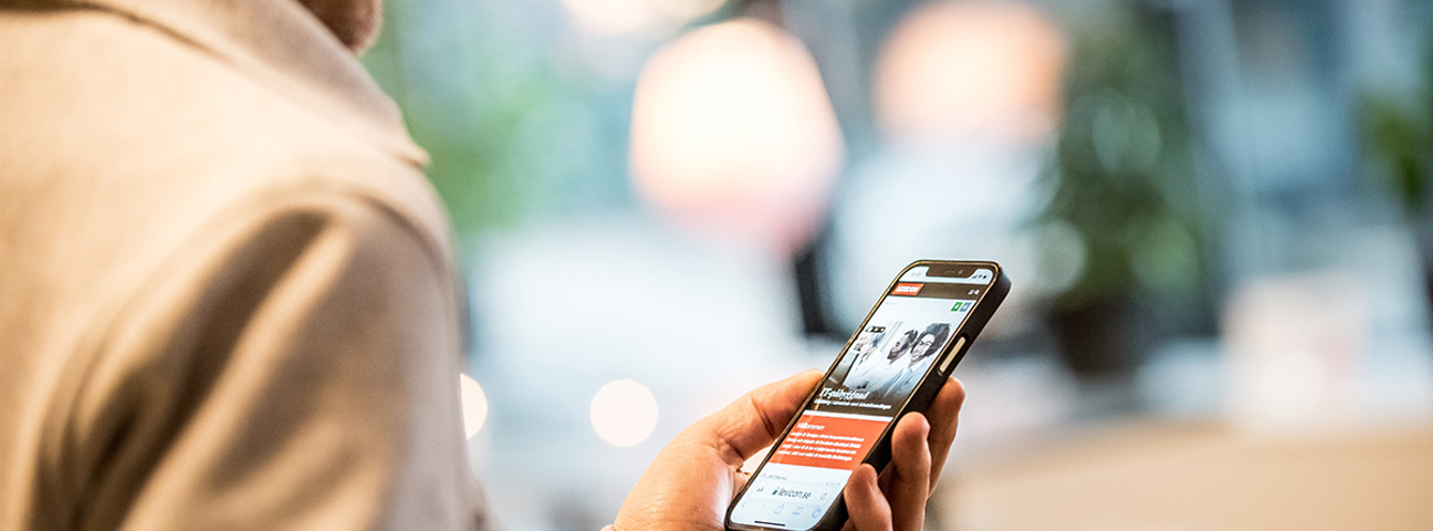 Man tittar i mobilen på Lexicons hemsida