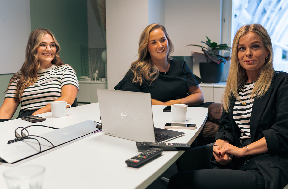 Tre tjejer runt ett konferensbord